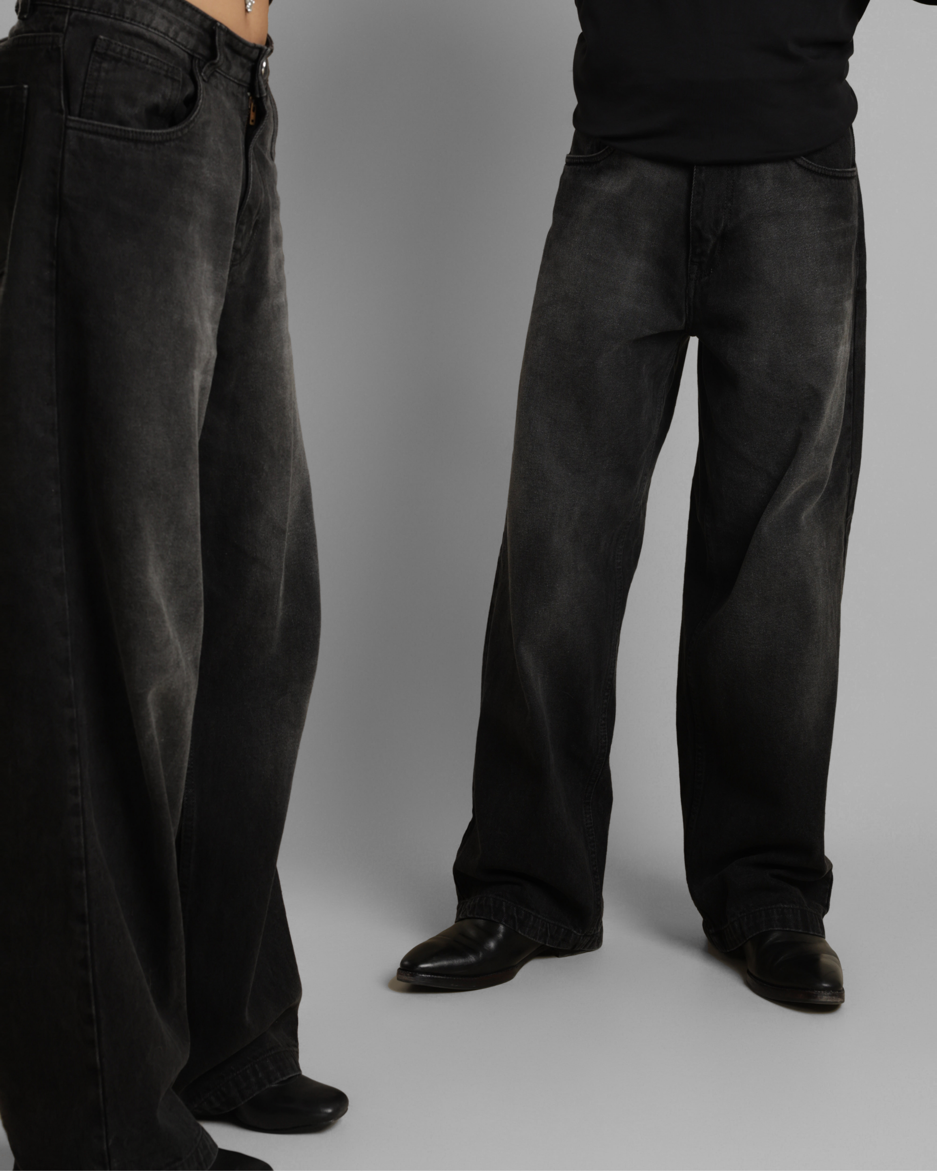 Two pairs of dark gray pants worn by models on a plain background