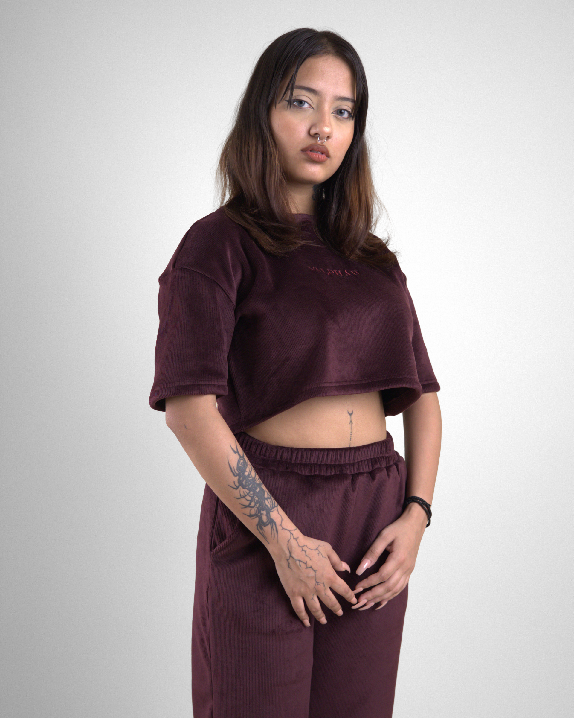 Person wearing a maroon outfit on a white background