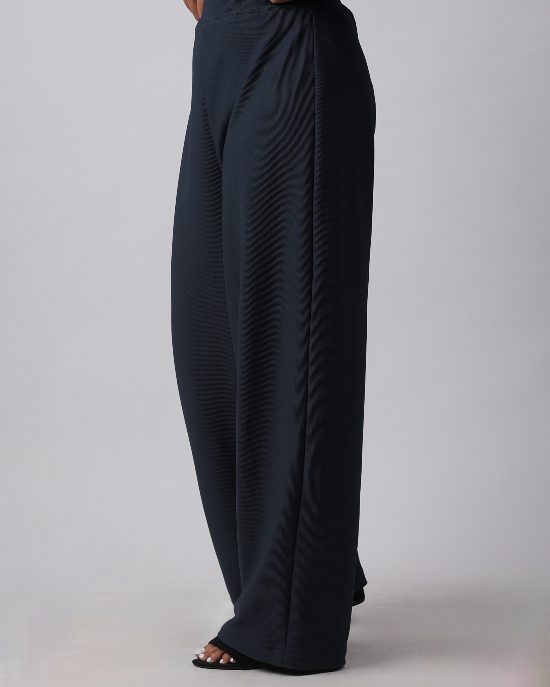Black wide-leg pants on a plain background
